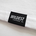 Close up of Wildest Clothing Co. brand tag on the bottom hem